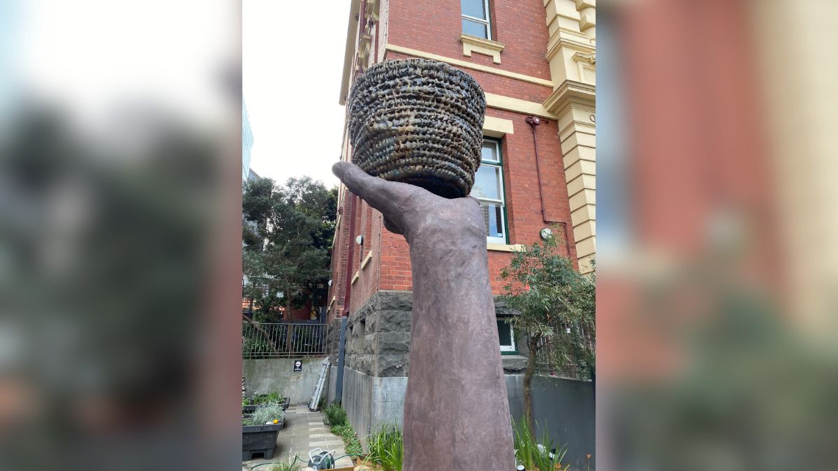 Creative Resilience artwork. A sculpture of a forearm and hand holding a basket. Located on Lonsdale Street outisde the Queen Victoria Womens Centre.
