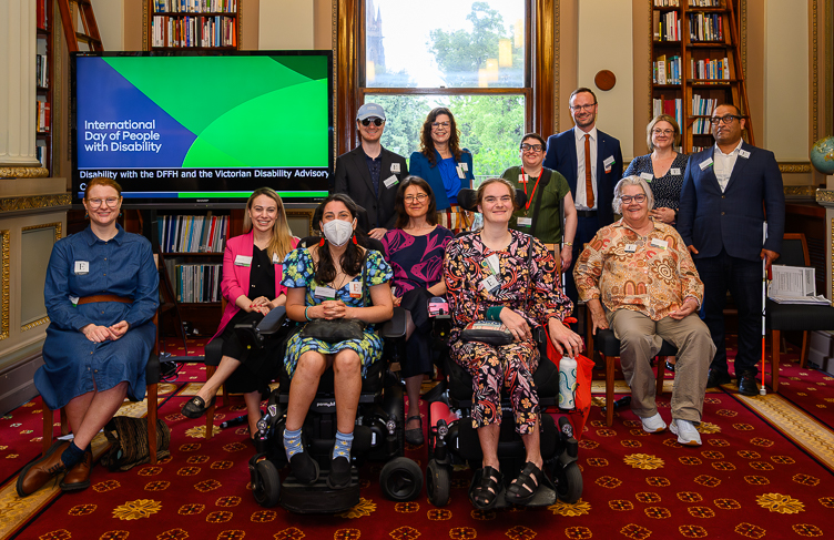 Members of the Victorian Disability Advisory Council. Back row all standing, from left to right: Timothy Harte, Nicole Karidis, Helen Freris, Chris Varney, Melissa Hale, Amir Brand-Abdi  From row all seated, left to right: Mija Gwyn, Bianca Failla, Laura Pettenuzzo, Jen Hargrave, Stella Barton, Katrina Harrison.