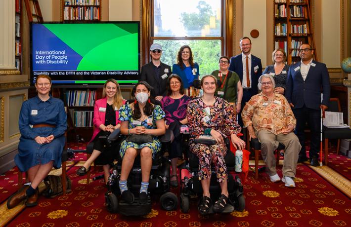 Members of the Victorian Disability Advisory Council. Back row all standing, from left to right: Timothy Harte, Nicole Karidis, Helen Freris, Chris Varney, Melissa Hale, Amir Brand-Abdi  From row all seated, left to right: Mija Gwyn, Bianca Failla, Laura Pettenuzzo, Jen Hargrave, Stella Barton, Katrina Harrison.
